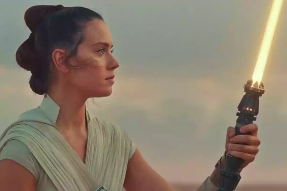 Woman with her hair up holds a yellow lightsaber while looking toward the horizon Woman with her hair up holds a yellow lightsaber while looking toward the horizon