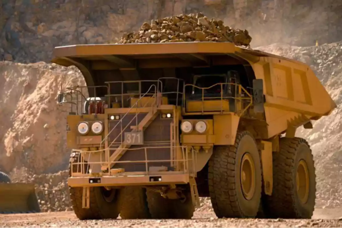 Giant mining truck hauling rocks in an open-pit mine