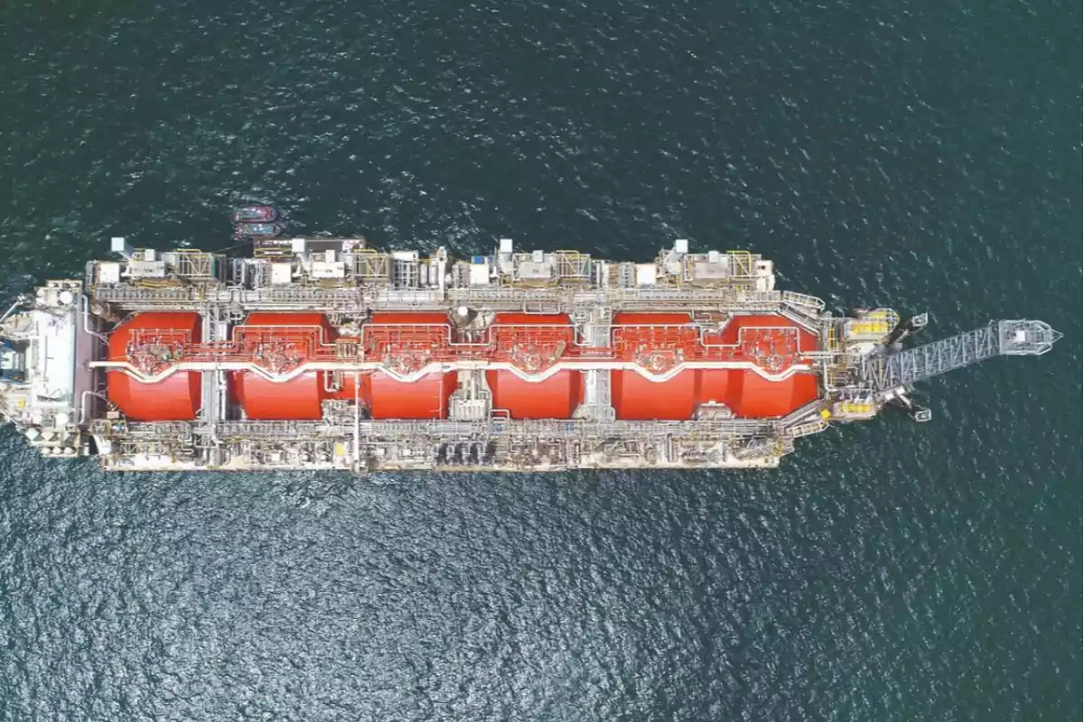 Aerial view of an industrial vessel with large red tanks sailing on the sea Aerial view of an industrial vessel with large red tanks sailing on the sea
