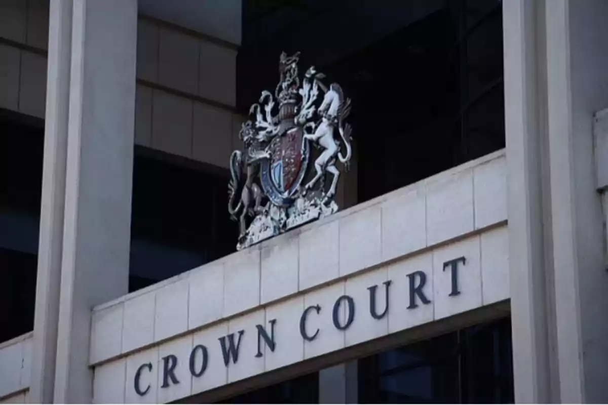 Facade of a building with the sign Crown Court and a coat of arms above the entrance Facade of a building with the sign Crown Court and a coat of arms above the entrance