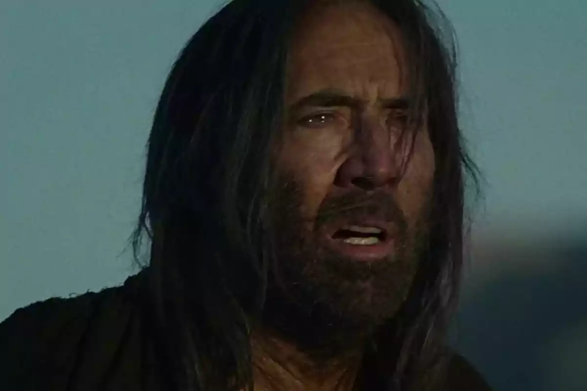 Long-haired, bearded man with a look of surprise or concern