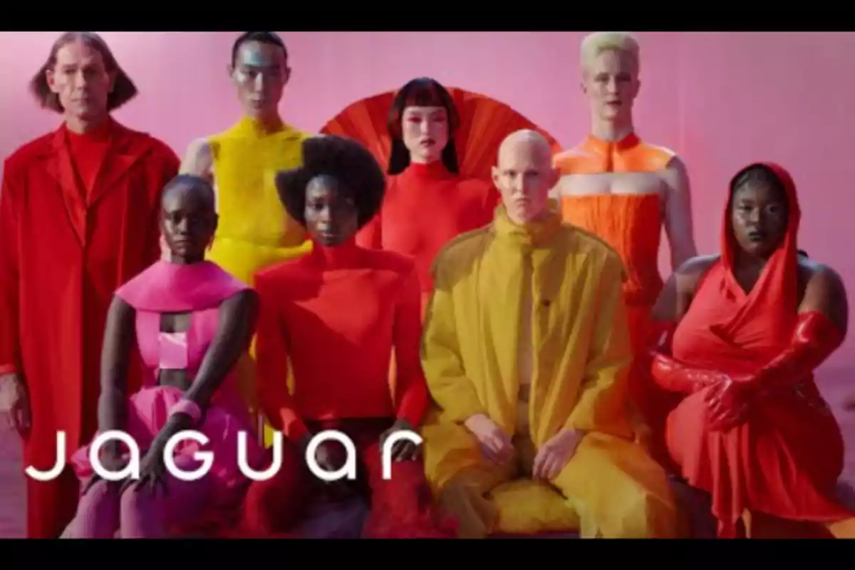 Group of people in colorful, modern clothing posing in front of a pink background with the word Group of people in colorful, modern clothing posing in front of a pink background with the word