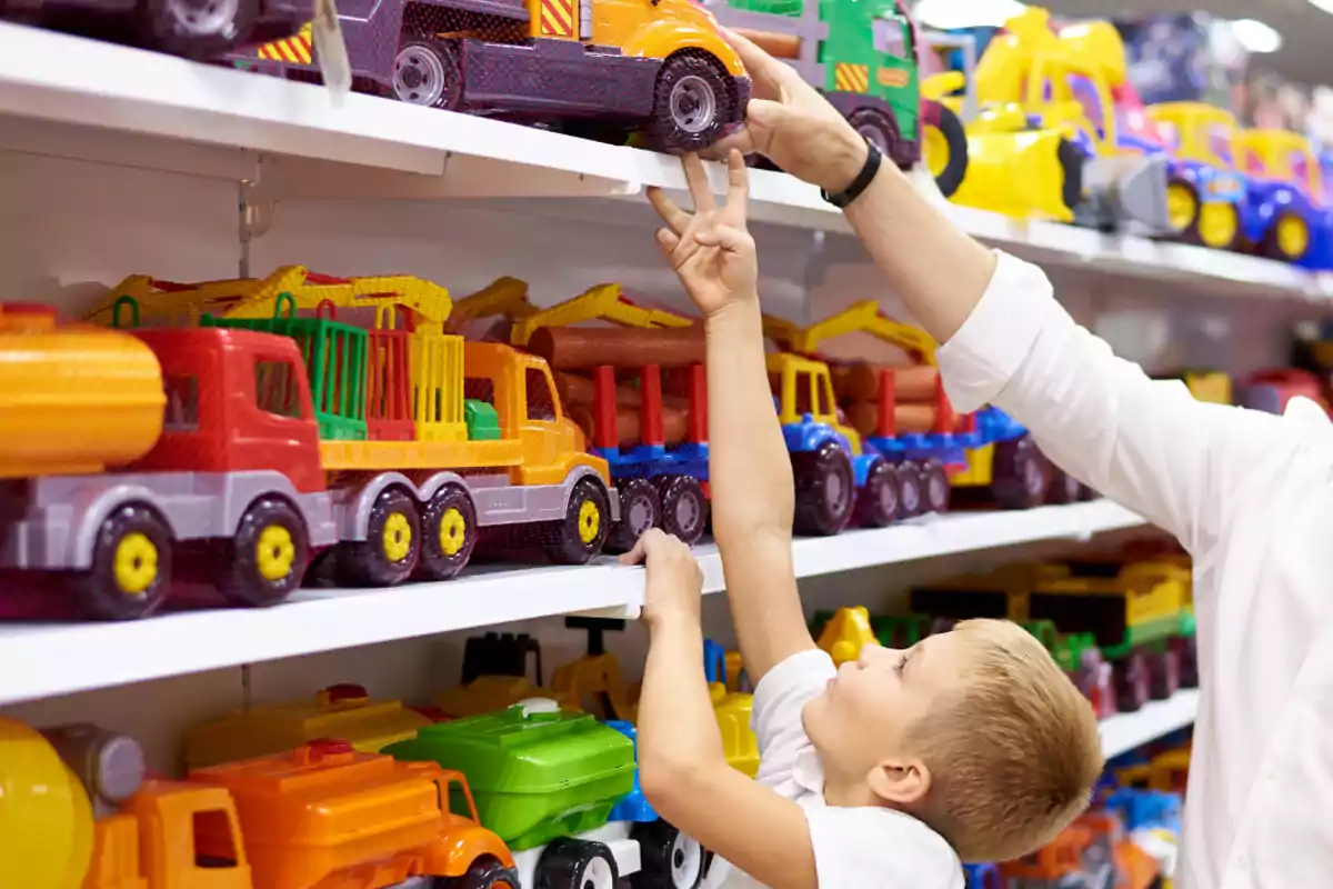 Child choosing a toy truck in a store accompanied by an adult