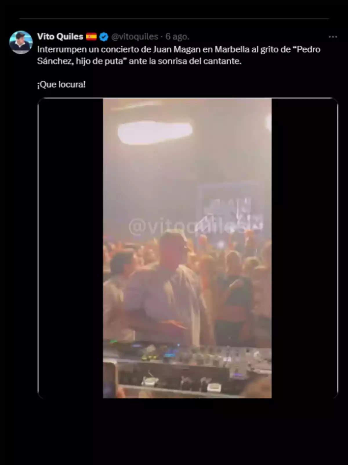 Man in a DJ booth during a concert with a crowd of people in the background in a party atmosphere. Man in a DJ booth during a concert with a crowd of people in the background in a party atmosphere.