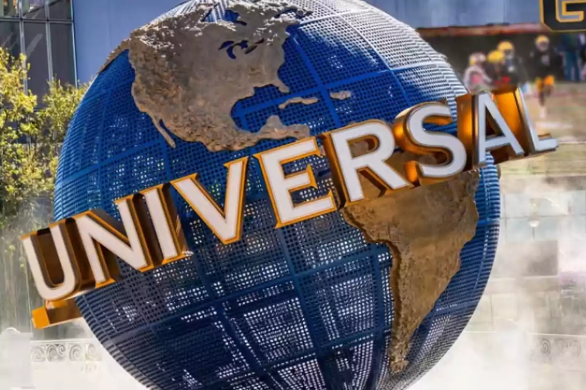 Blue globe with the Universal logo in gold letters in front of a building Blue globe with the Universal logo in gold letters in front of a building