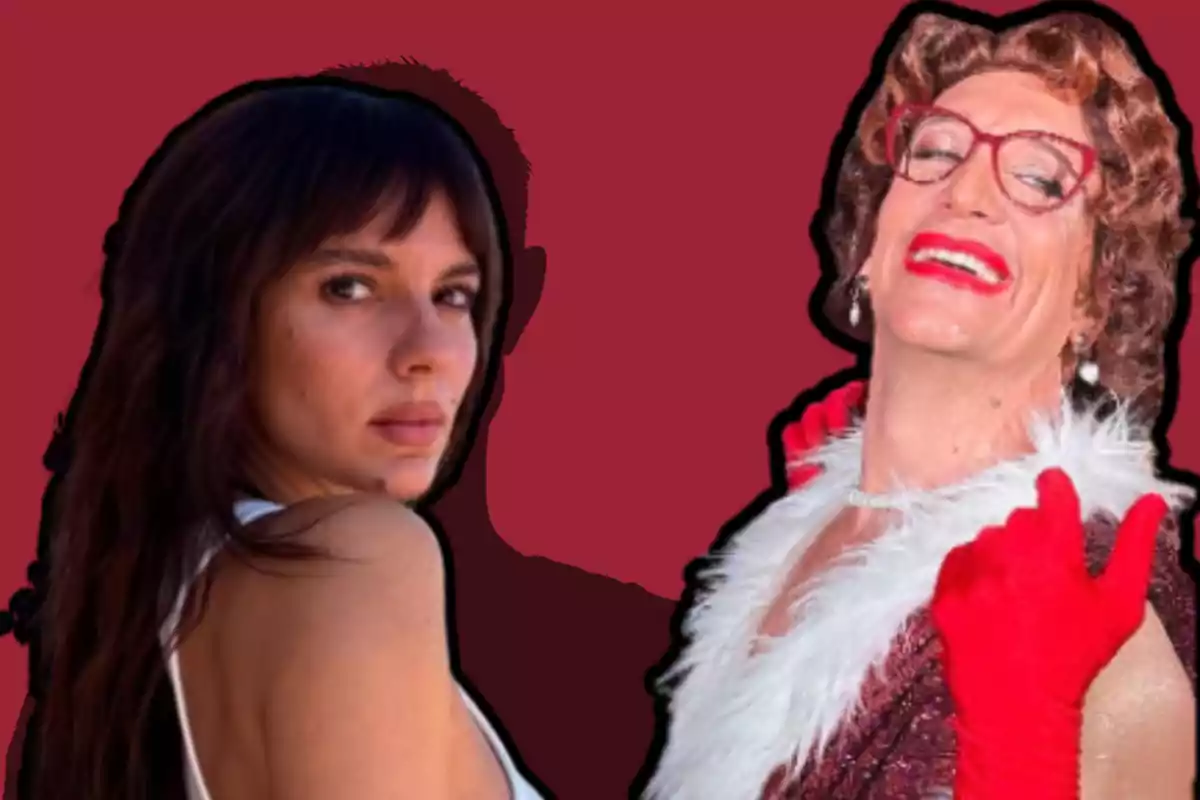 Two people pose in front of a red background, one with long dark hair looking at the camera and the other wearing a wig, glasses, red gloves, and a white boa, smiling broadly.