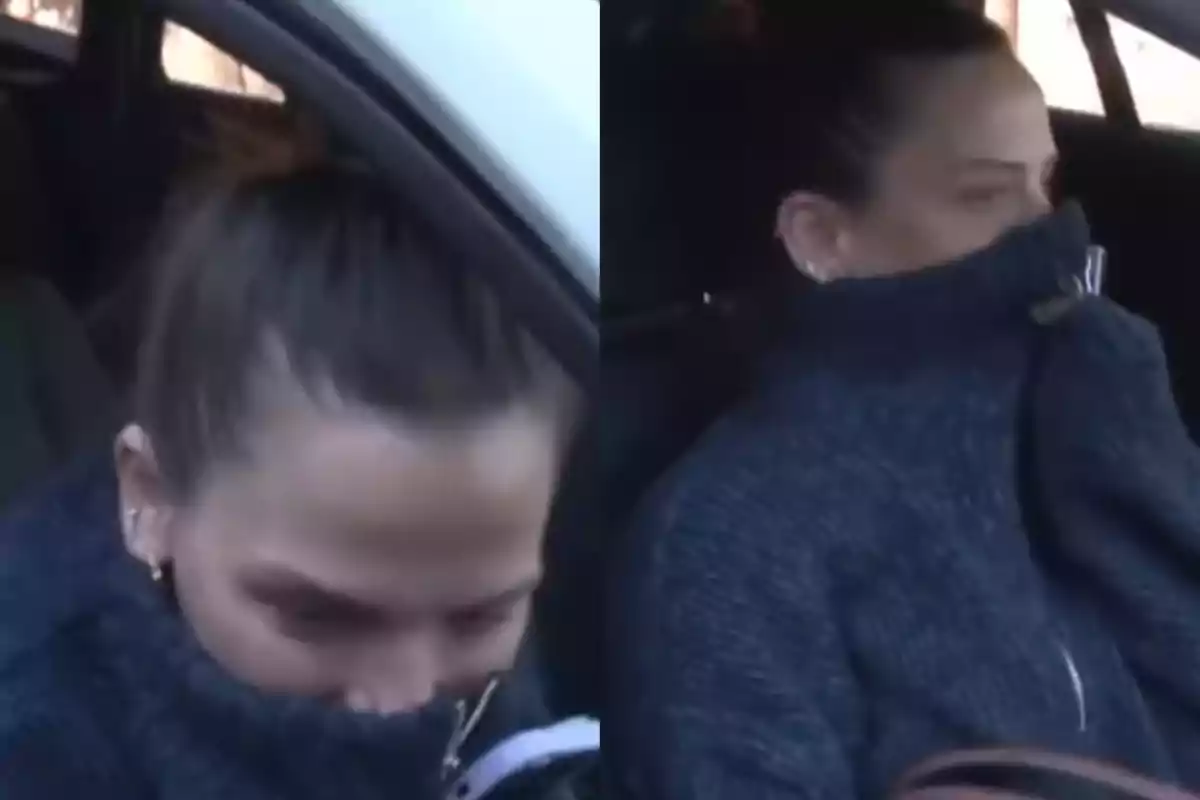 Woman sitting in a car covering her mouth and nose with a dark blue sweater Woman sitting in a car covering her mouth and nose with a dark blue sweater