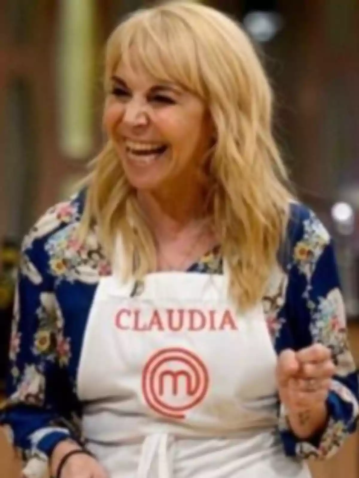 Smiling blonde woman wearing a white MasterChef apron with the name Claudia Smiling blonde woman wearing a white MasterChef apron with the name Claudia