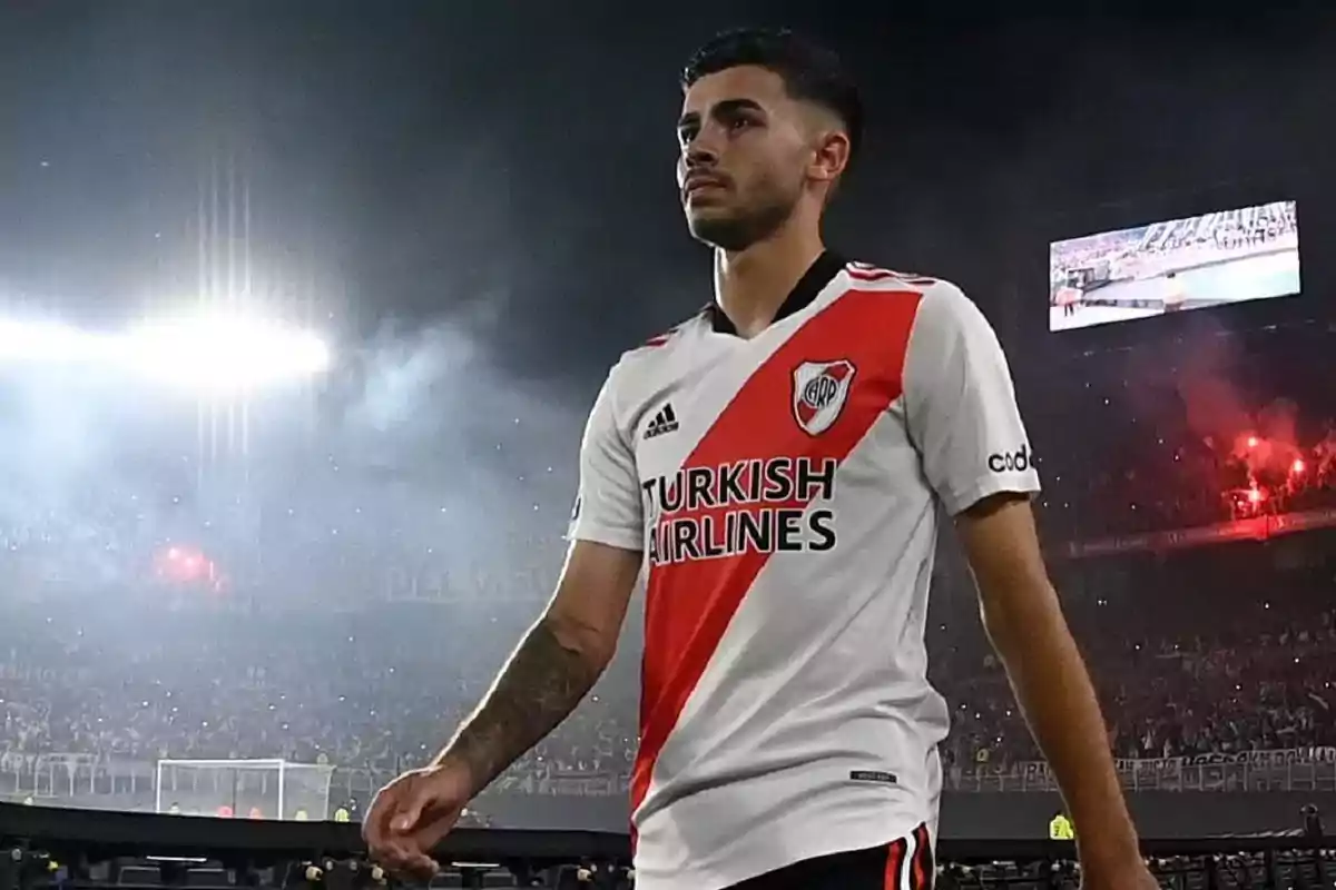 River Plate player walking in the stadium during a night match with smoke and lights in the background River Plate player walking in the stadium during a night match with smoke and lights in the background