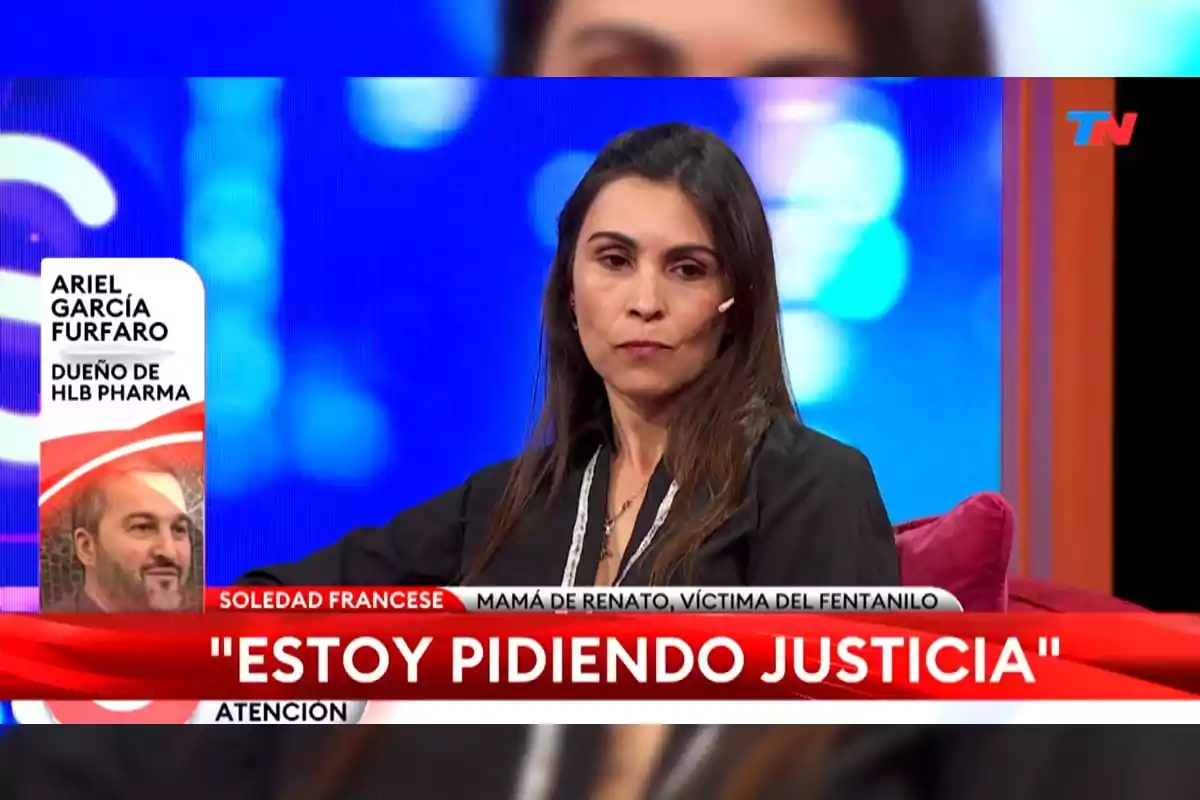 Woman sitting on a TV show with a serious expression, the text on the screen reads Woman sitting on a TV show with a serious expression, the text on the screen reads