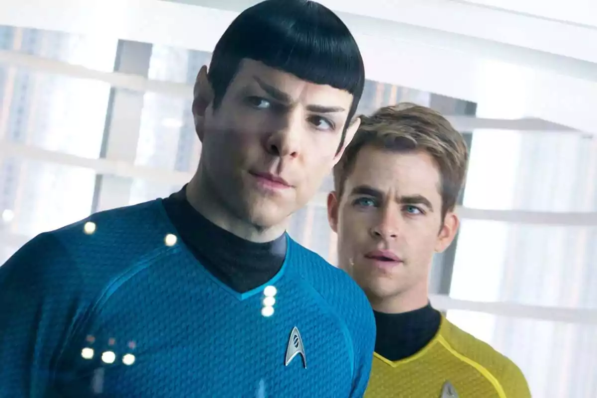 Two Star Trek characters in blue and yellow uniforms are observing something through a window inside a futuristic spaceship. Two Star Trek characters in blue and yellow uniforms are observing something through a window inside a futuristic spaceship.