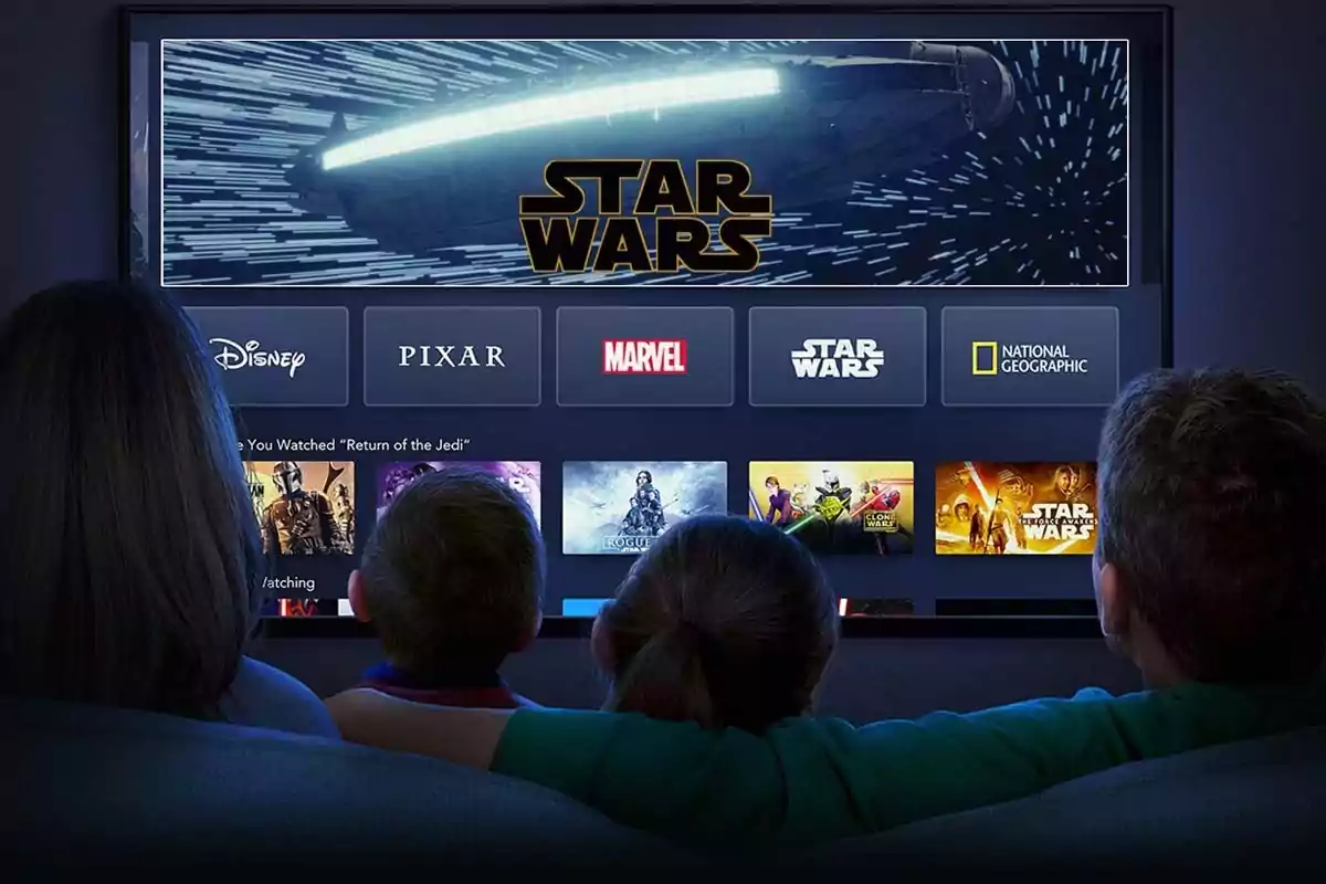 Family sitting on a couch watching a television screen displaying the Disney Plus interface with content options like Star Wars, Marvel, Pixar, and National Geographic. Family sitting on a couch watching a television screen displaying the Disney Plus interface with content options like Star Wars, Marvel, Pixar, and National Geographic.