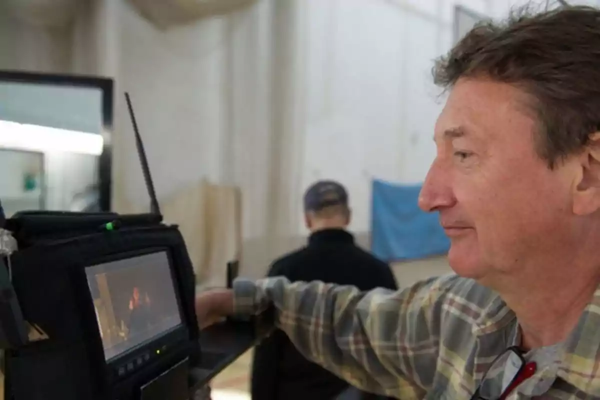 Man watching a recording monitor on a film set Man watching a recording monitor on a film set