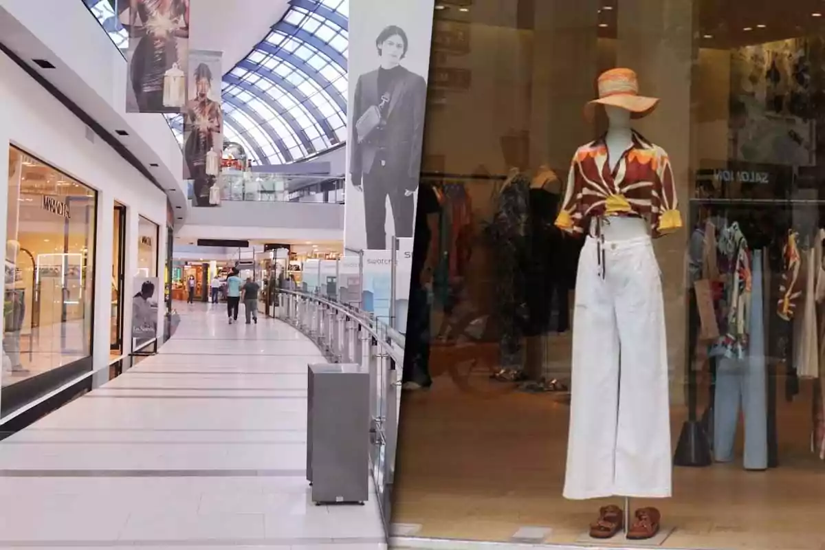 Interior de un centro comercial moderno con tiendas de ropa y un maniquí en un escaparate vistiendo pantalones blancos y blusa colorida