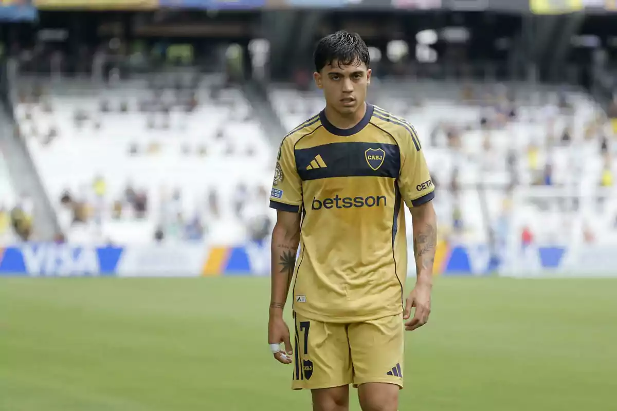 Soccer player wearing Boca Juniors’ gold uniform on the field during a match