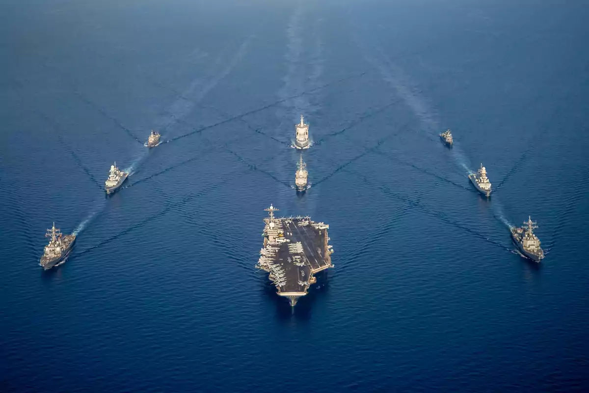 Formation of several warships sailing on the sea seen from above Formation of several warships sailing on the sea seen from above