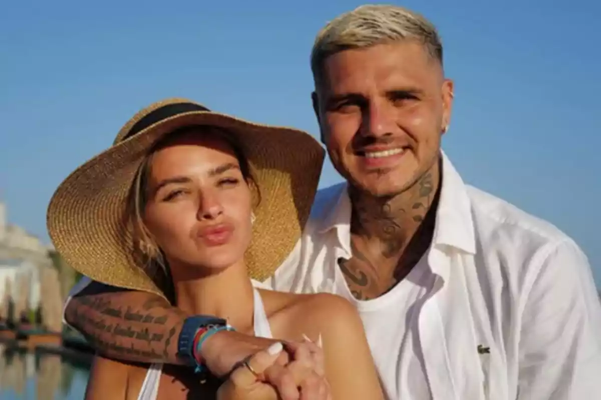 Couple posing outdoors under a clear sky, the woman wearing a wide-brimmed hat and the man dressed in a white jersey Couple posing outdoors under a clear sky, the woman wearing a wide-brimmed hat and the man dressed in a white jersey