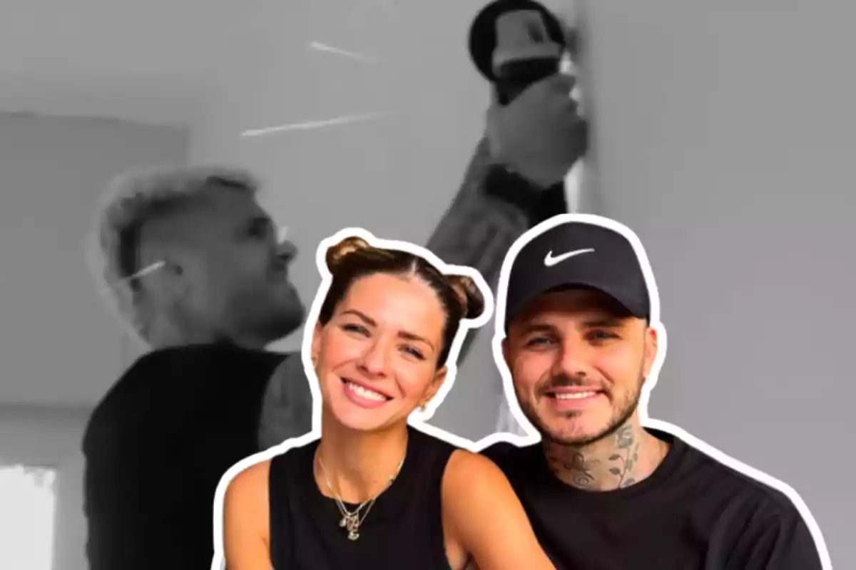 A woman and a man smile in the foreground with a black and white background where another person is using a tool on the wall.