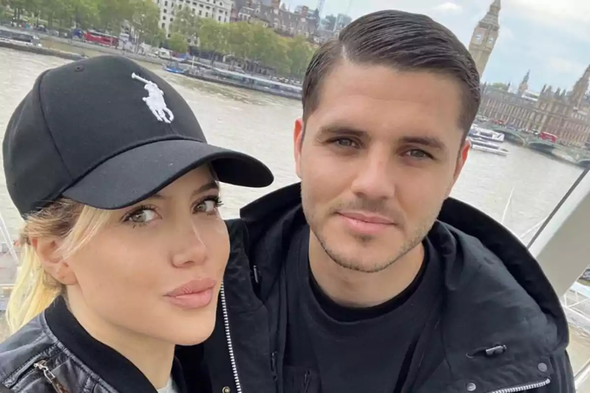 Couple taking a selfie with the River Thames and Big Ben in the background in London