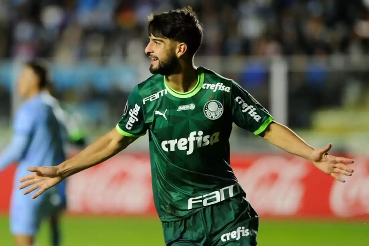 Soccer player in a green Palmeiras uniform celebrating on the field with arms outstretched Soccer player in a green Palmeiras uniform celebrating on the field with arms outstretched
