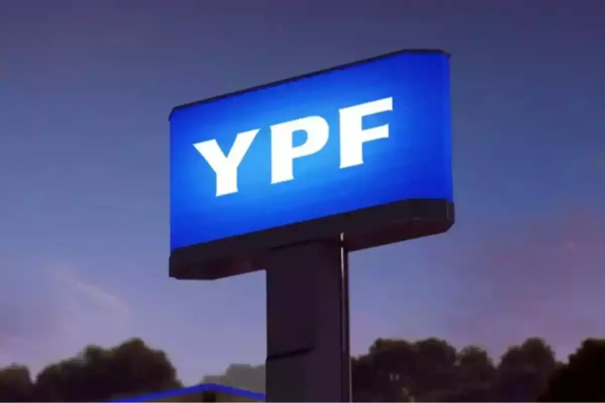 Illuminated YPF gas station sign against a sunset sky background Illuminated YPF gas station sign against a sunset sky background
