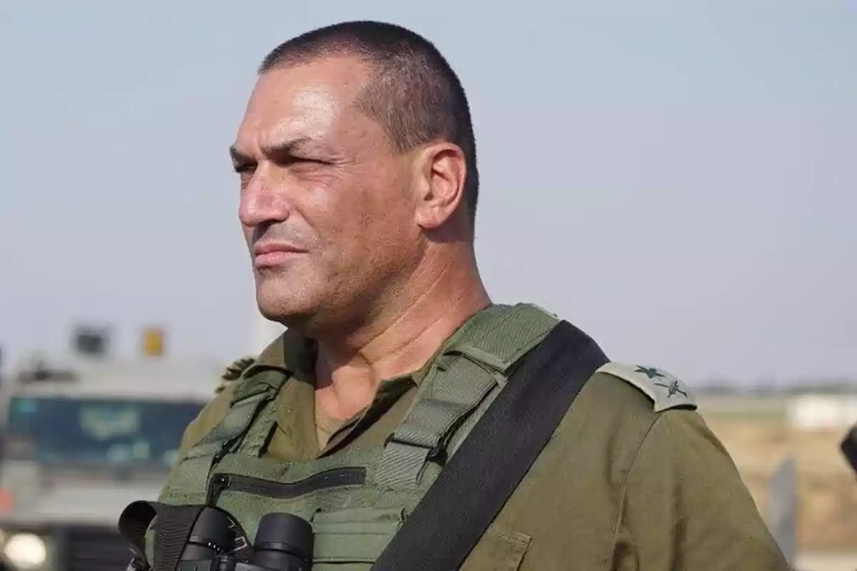 Man in military uniform with binoculars around his neck looking to the left in an outdoor setting Man in military uniform with binoculars around his neck looking to the left in an outdoor setting