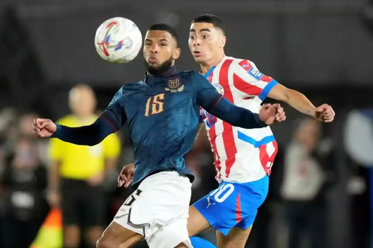 Two players compete for the ball during a match between Ecuador and Paraguay. Two players compete for the ball during a match between Ecuador and Paraguay.