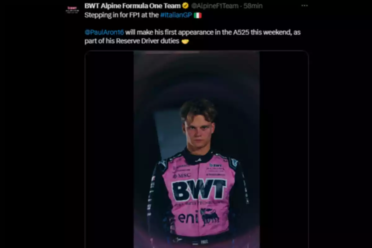 Alpine driver wearing a pink and black racing suit with the BWT logo, posing in front of a dark background Alpine driver wearing a pink and black racing suit with the BWT logo, posing in front of a dark background