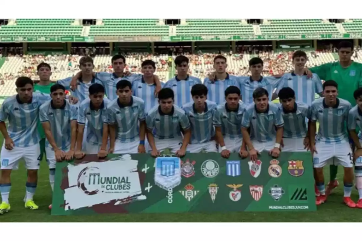 Youth soccer team posing on a field in light blue and white uniforms, holding a Club World Cup banner alongside the crests of several well-known teams