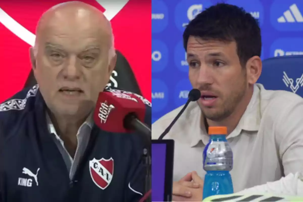 Two men at sports press conferences, one wearing an Independiente jacket and the other in a light jersey in front of a blue background Two men at sports press conferences, one wearing an Independiente jacket and the other in a light jersey in front of a blue background
