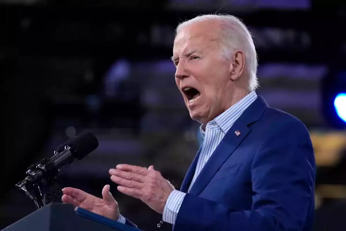Elderly man with gray hair speaking passionately into a microphone during a public event Elderly man with gray hair speaking passionately into a microphone during a public event
