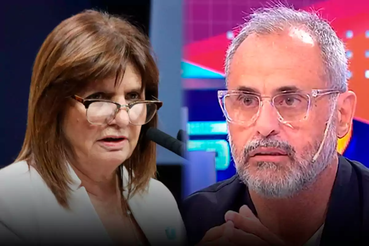 A woman with glasses and light brown hair is speaking into a microphone while a bearded man with clear glasses watches her in a television studio with a colorful background.