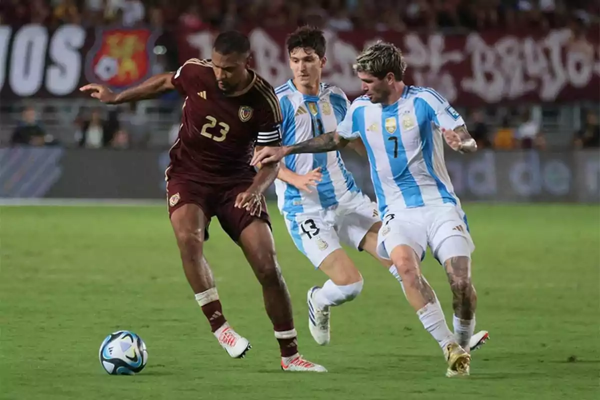 Three players fight for the ball during a match between the national teams of Venezuela and Argentina. Three players fight for the ball during a match between the national teams of Venezuela and Argentina.