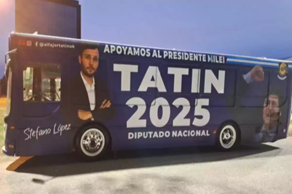 A bus with political advertising displaying the image of a man in a suit, the name Tatin 2025, and the text A bus with political advertising displaying the image of a man in a suit, the name Tatin 2025, and the text