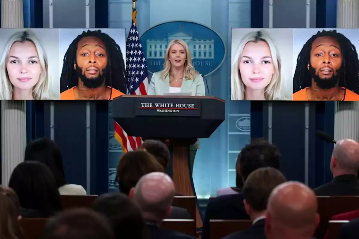 A blonde woman is giving a press conference at the White House in front of an audience, while on two large screens appear photos of a woman and a man with dreadlocks, both shown on both screens.