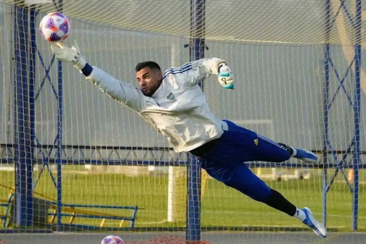 Soccer goalkeeper making a spectacular save during training, stretching out in the air to stop the ball near the corner of the goal. Soccer goalkeeper making a spectacular save during training, stretching out in the air to stop the ball near the corner of the goal.
