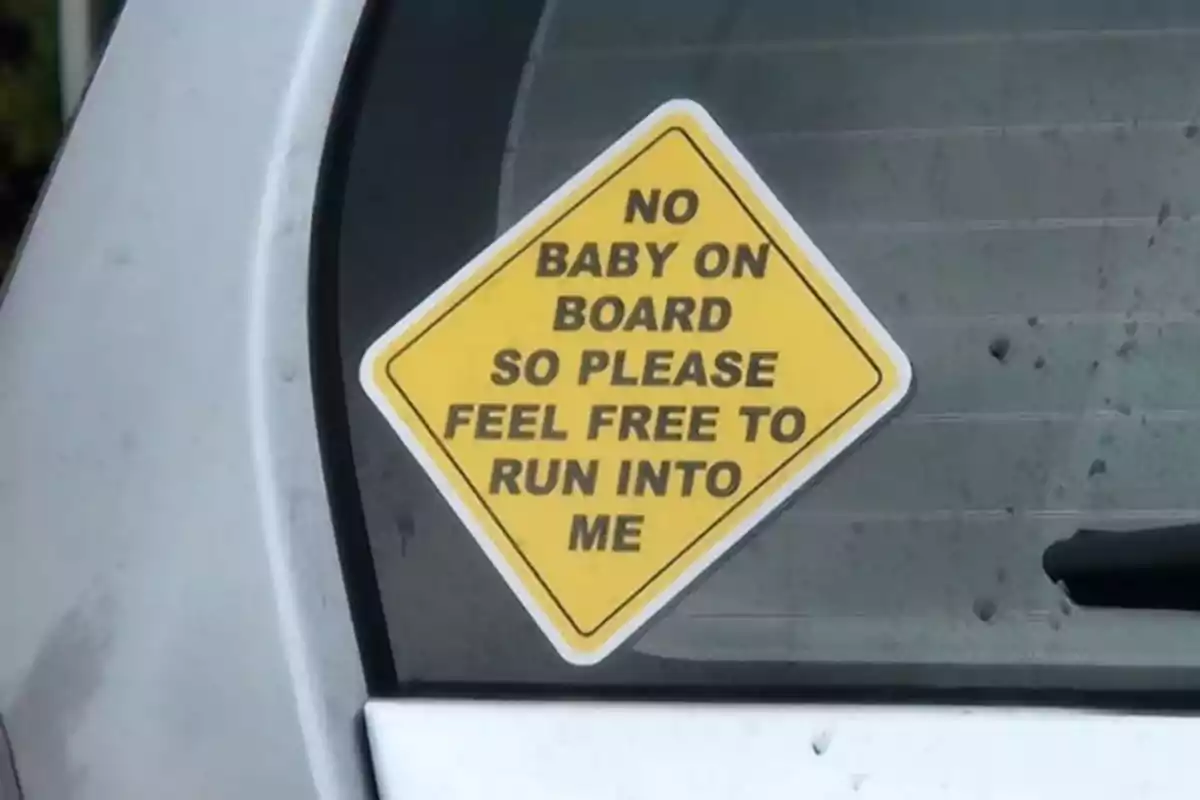 Yellow sticker on the rear window of a car with a sarcastic message saying there’s no baby on board and you can crash into the vehicle. Yellow sticker on the rear window of a car with a sarcastic message saying there’s no baby on board and you can crash into the vehicle.