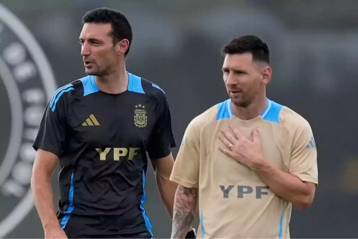 Two men wearing Argentina national team sportswear are talking on a training field. Two men wearing Argentina national team sportswear are talking on a training field.