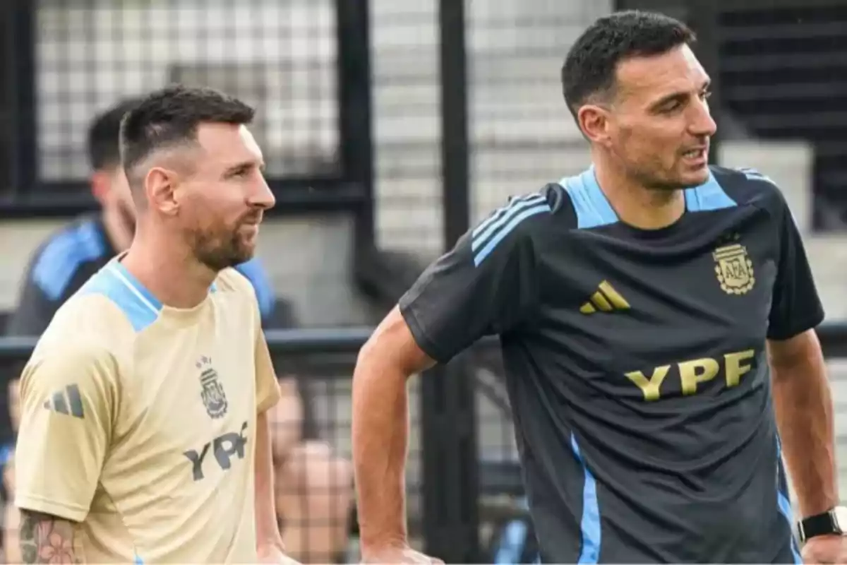 Two men wearing Argentina national team sportswear talk during a training session.