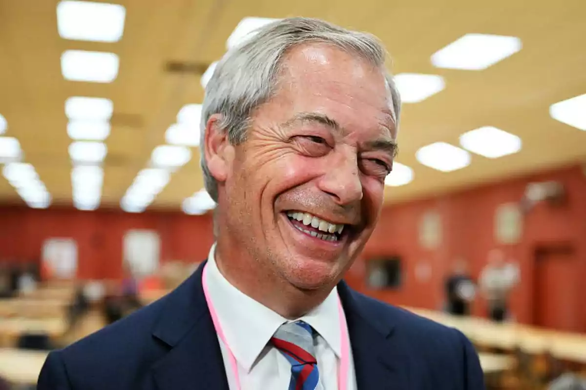 Gray-haired man smiling broadly in a room lit by rectangular ceiling lights Gray-haired man smiling broadly in a room lit by rectangular ceiling lights