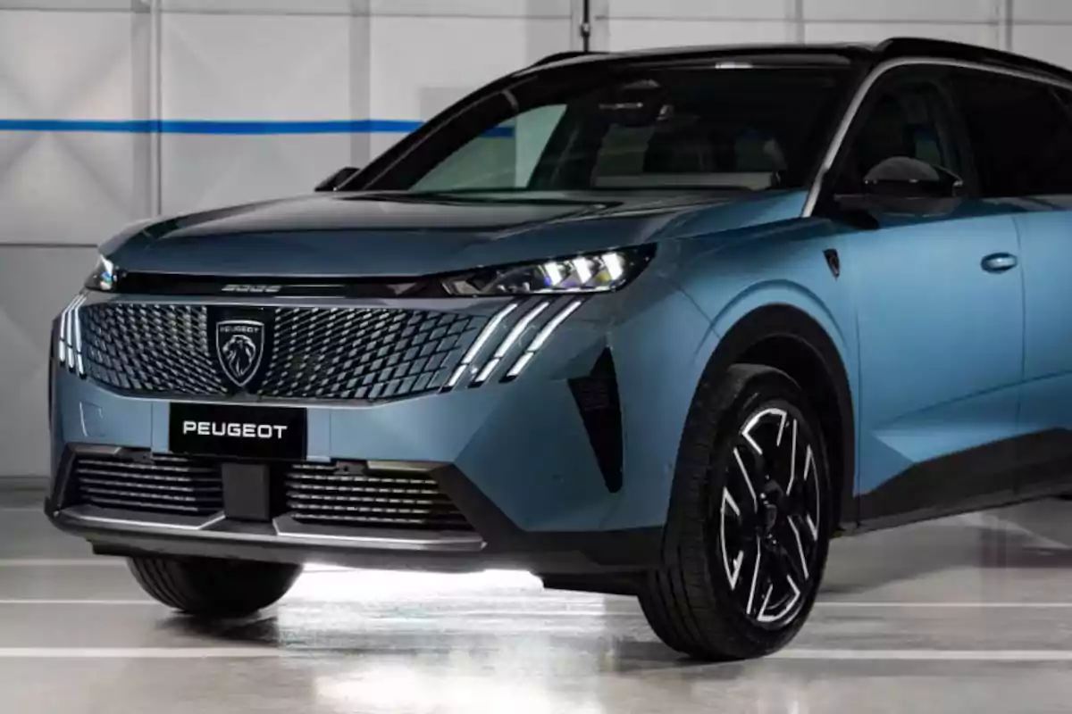 Blue Peugeot SUV parked in a garage with modern design and chrome details on the front grille Blue Peugeot SUV parked in a garage with modern design and chrome details on the front grille