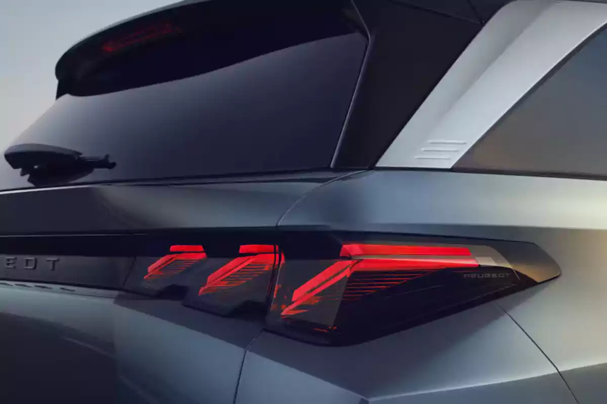 Detail of the rear part of a Peugeot car with taillights on and modern design Detail of the rear part of a Peugeot car with taillights on and modern design
