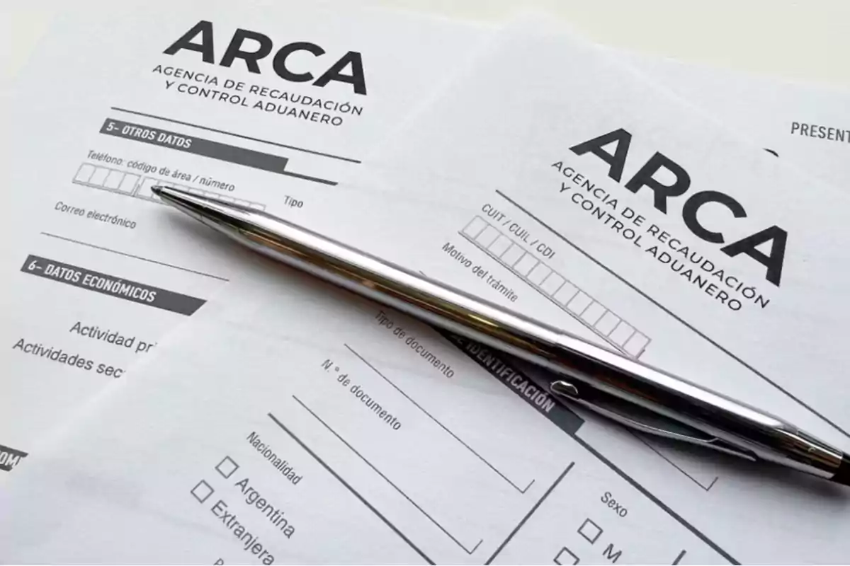 Forms from the Revenue and Customs Control Agency with a silver pen on top