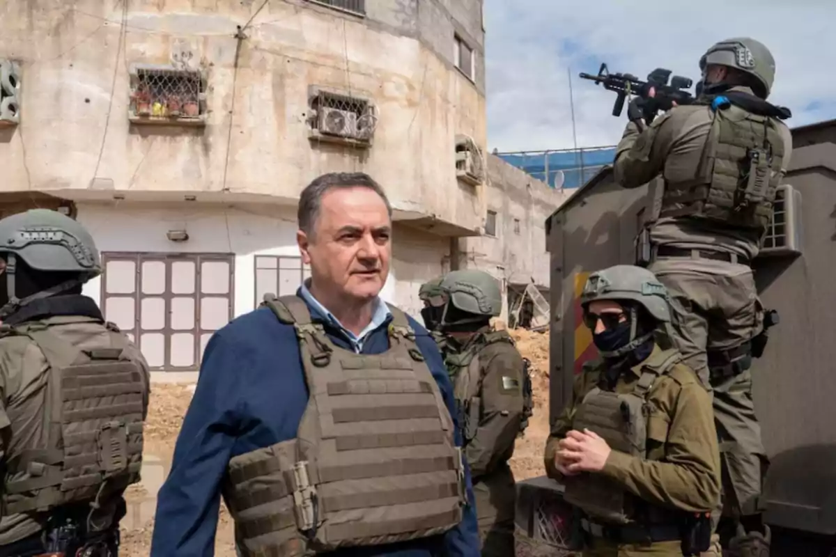 Man wearing a bulletproof vest surrounded by armed soldiers in an urban area with dilapidated buildings Man wearing a bulletproof vest surrounded by armed soldiers in an urban area with dilapidated buildings