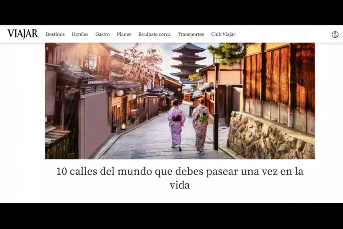 Two people in kimonos walk down a traditional Japanese street with wooden houses and a pagoda in the background. Two people in kimonos walk down a traditional Japanese street with wooden houses and a pagoda in the background.
