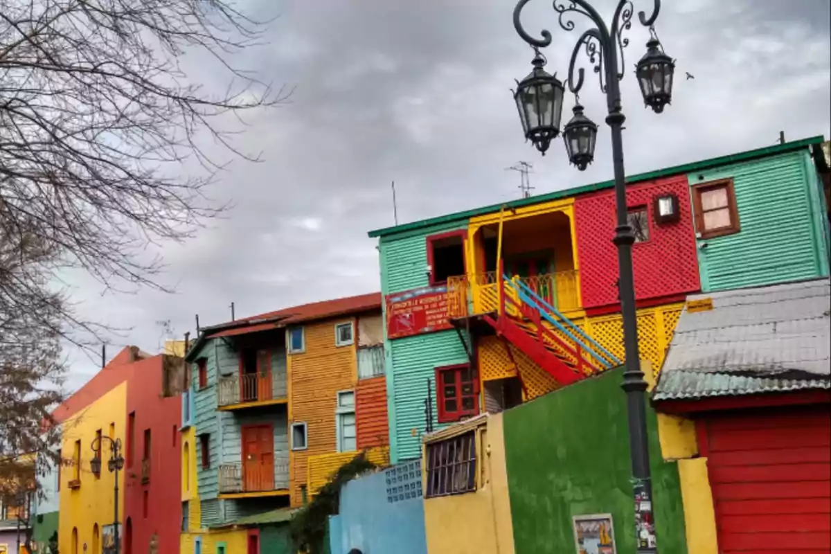 Vibrantly colored houses on a traditional street with an old lantern and cloudy sky Vibrantly colored houses on a traditional street with an old lantern and cloudy sky