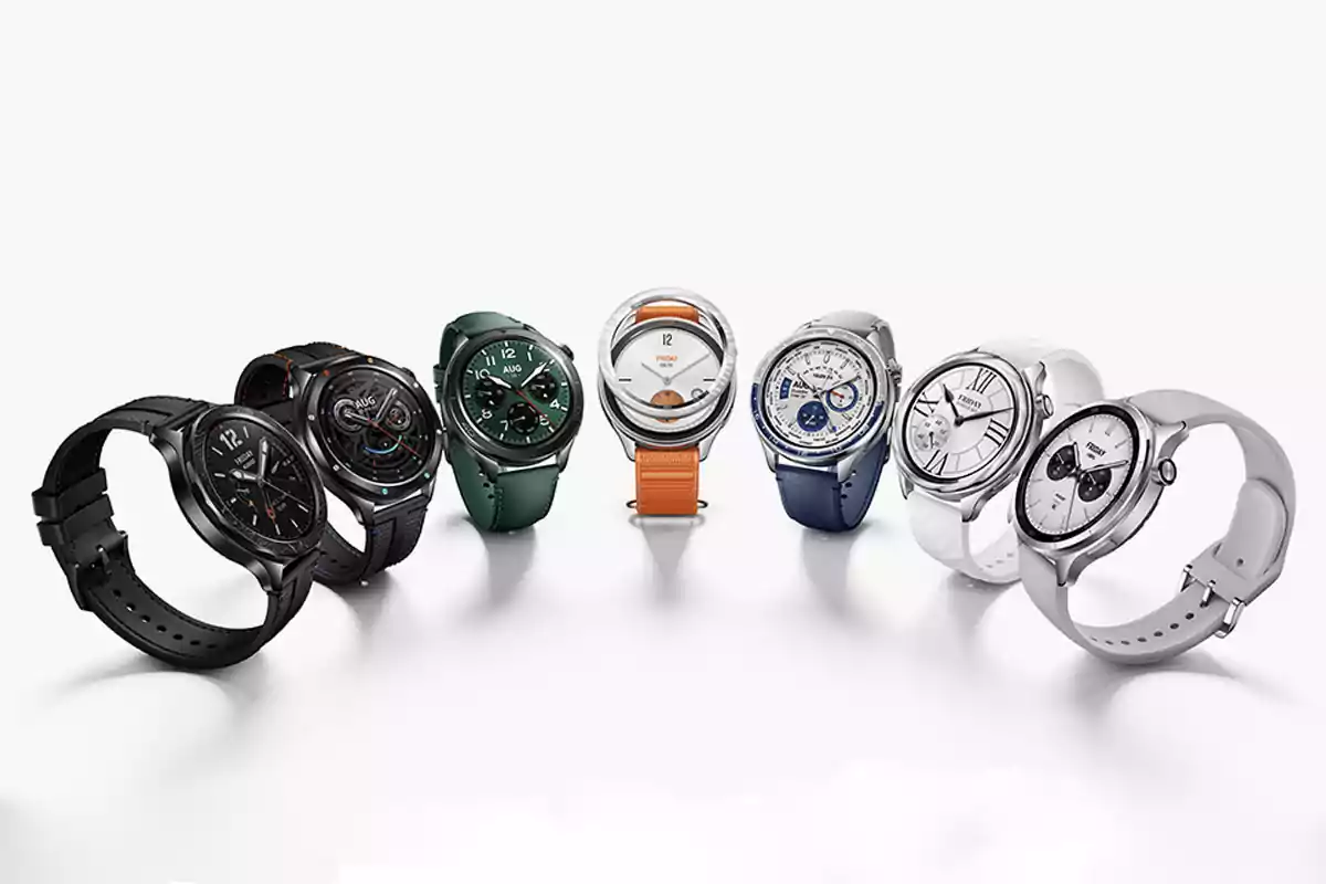 Several smartwatches of different colors and styles lined up on a white surface. Several smartwatches of different colors and styles lined up on a white surface.