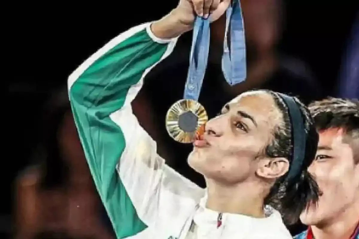 Athlete kissing a gold medal while wearing a green and white sports uniform Athlete kissing a gold medal while wearing a green and white sports uniform