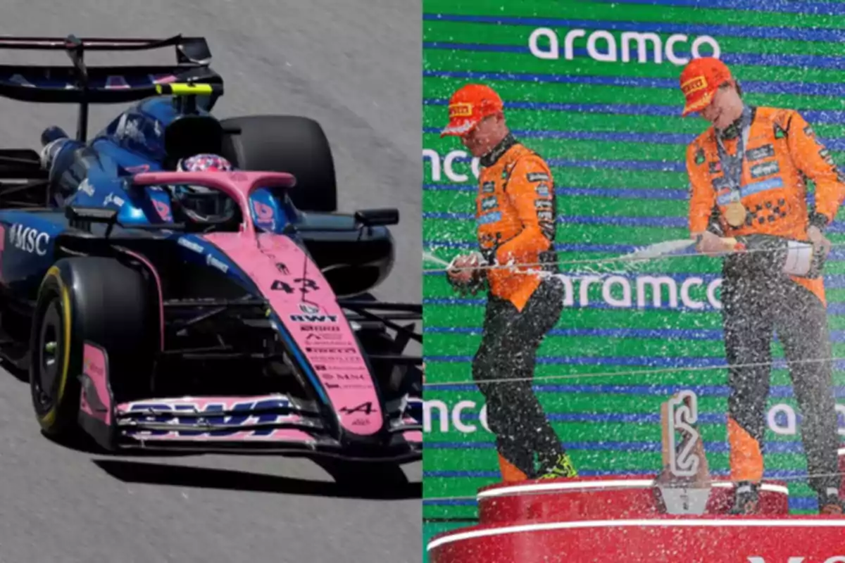 A blue and pink Formula 1 car on the track alongside two drivers celebrating on the podium in orange suits with champagne
