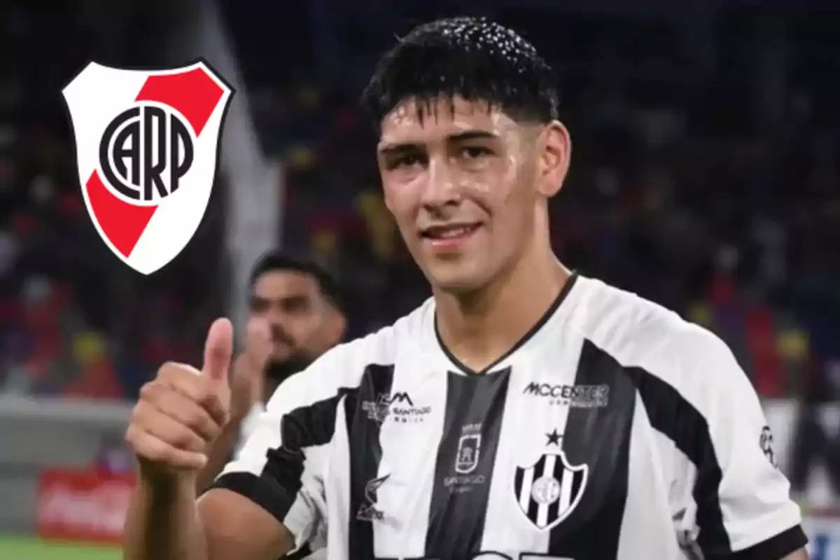 Soccer player wearing a white and black jersey smiles and gives a thumbs-up gesture, while the River Plate crest appears in the upper left corner.